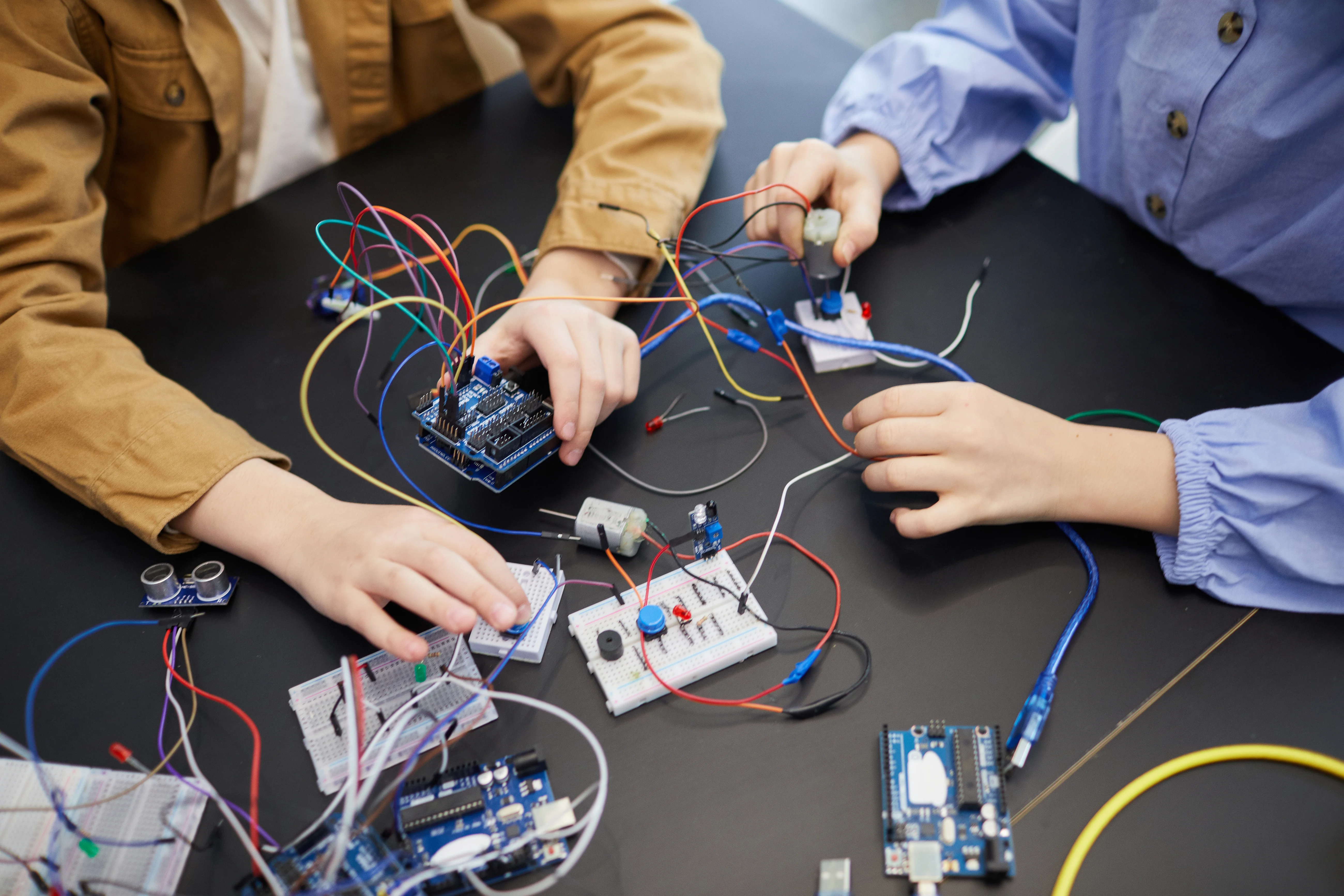 children-working-with-electrical-components-on-bla-2026-01-08-07-43-03-utc